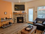 Large Smart TV, gas fireplace, and entertainment center